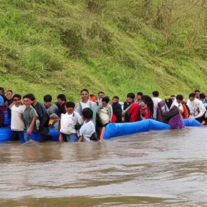 a group of people standing next to a body of water